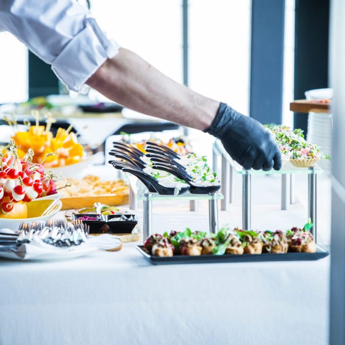 the waiter makes the organization of snacks on the table, before the arrival of the guests