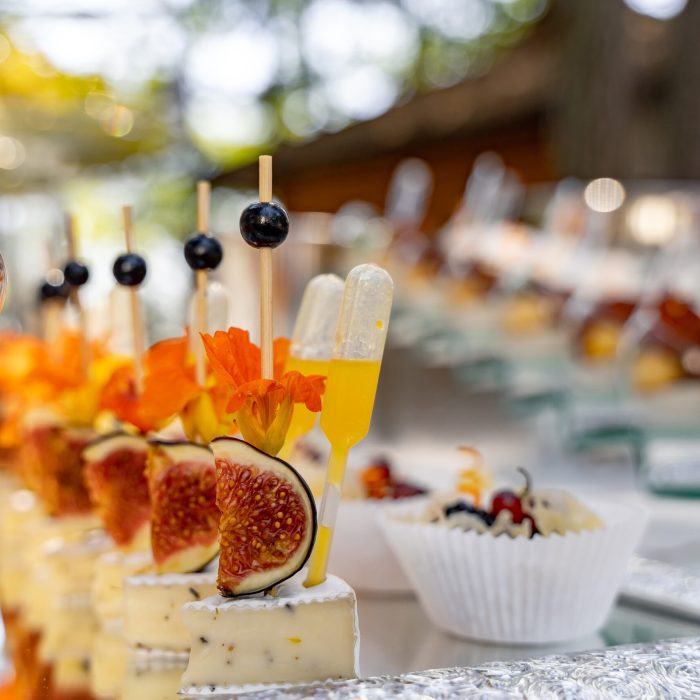 Banquet event. Table with glasses, snacks and appetizers. Celebrating event. Blurred background.