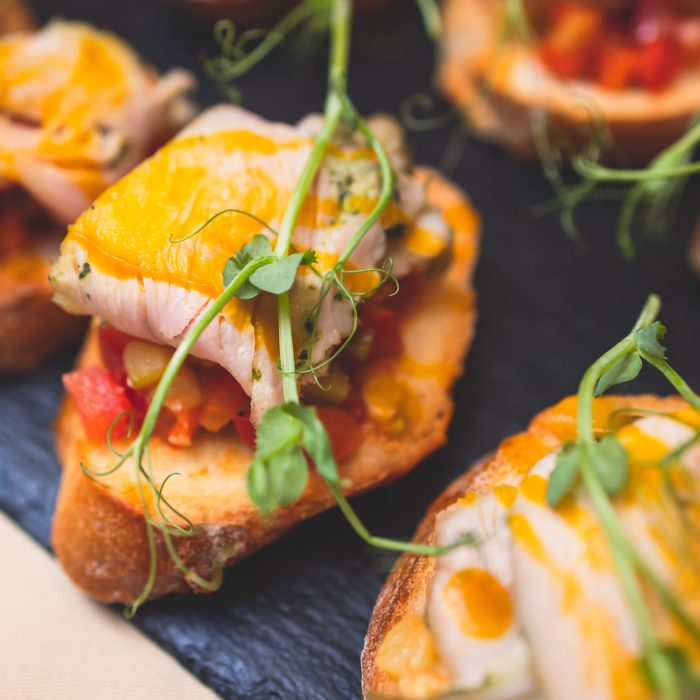 Catering table, beautifully decorated banquet with variety of with different food snacks and appetizers on corporate birthday party event or wedding celebration, delicatessen setting